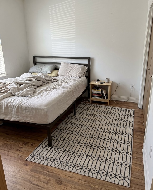 Wharton Geometric lattice rug, white and gray, 5×8, in a room