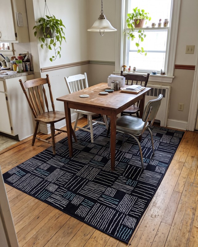 Snowberry Linear grid rug, navy, ivory, teal, 5×8, in a room