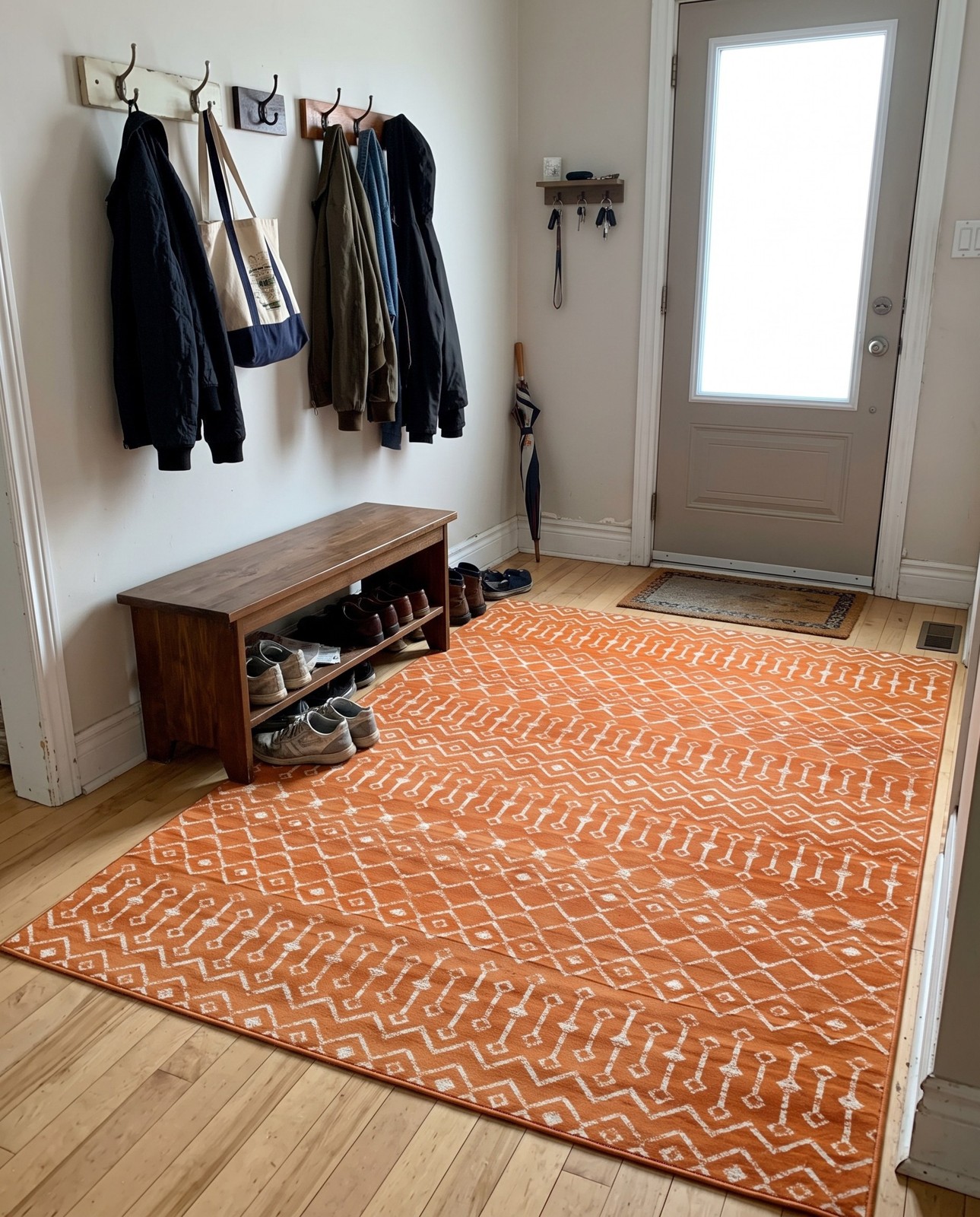 7' 10 x 11' Dudley · Geometric trellis rug, orange and ivory
