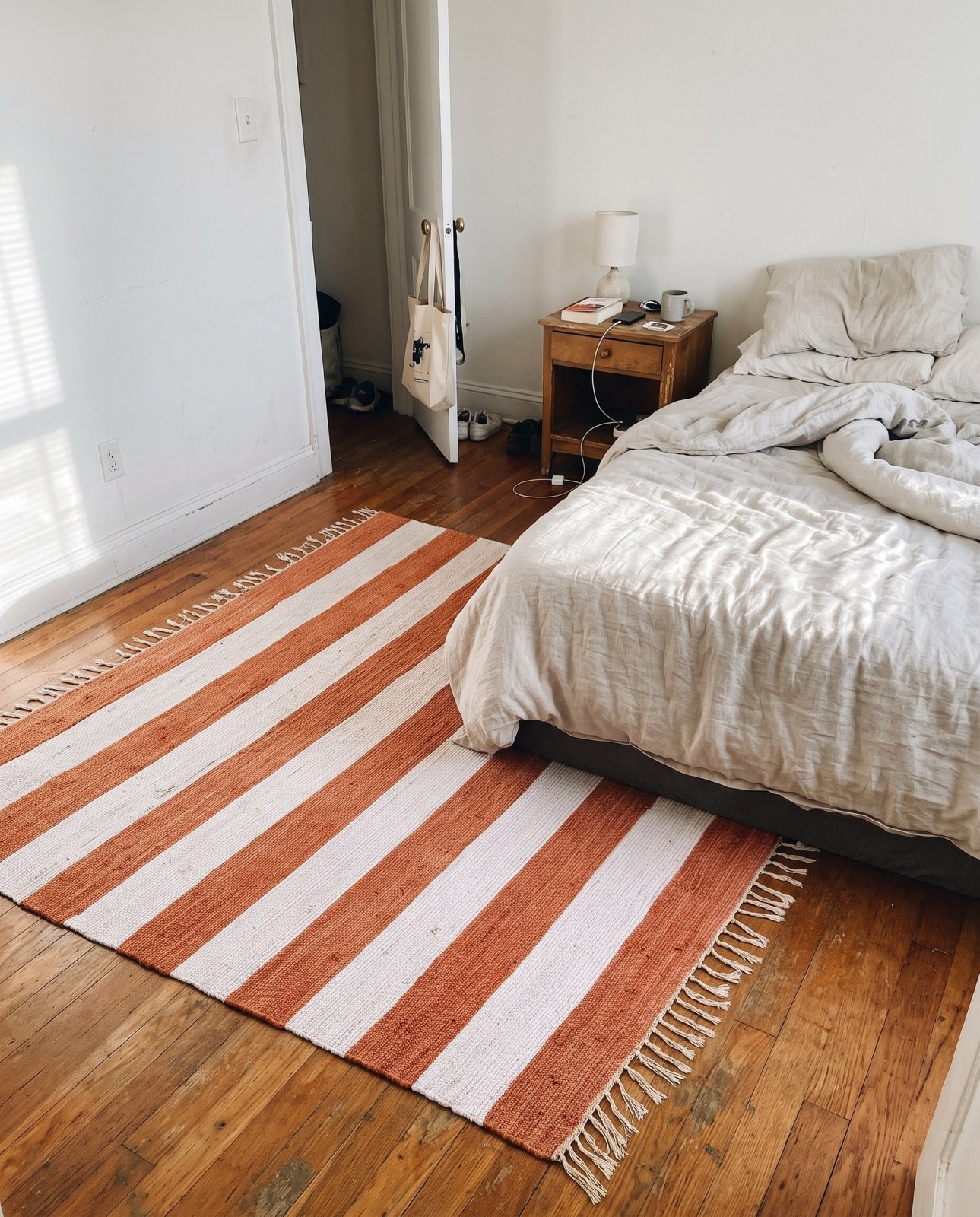 Detail image of 7' 10 x 7' 10 Flagstaff · Striped Chindi Rug, coral and ivory