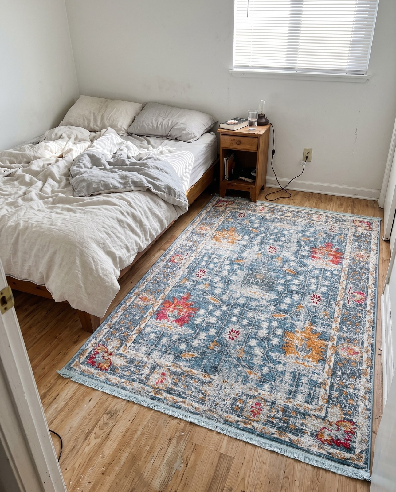 5' 5 x 8' Calm · Distressed floral rug, blue and orange