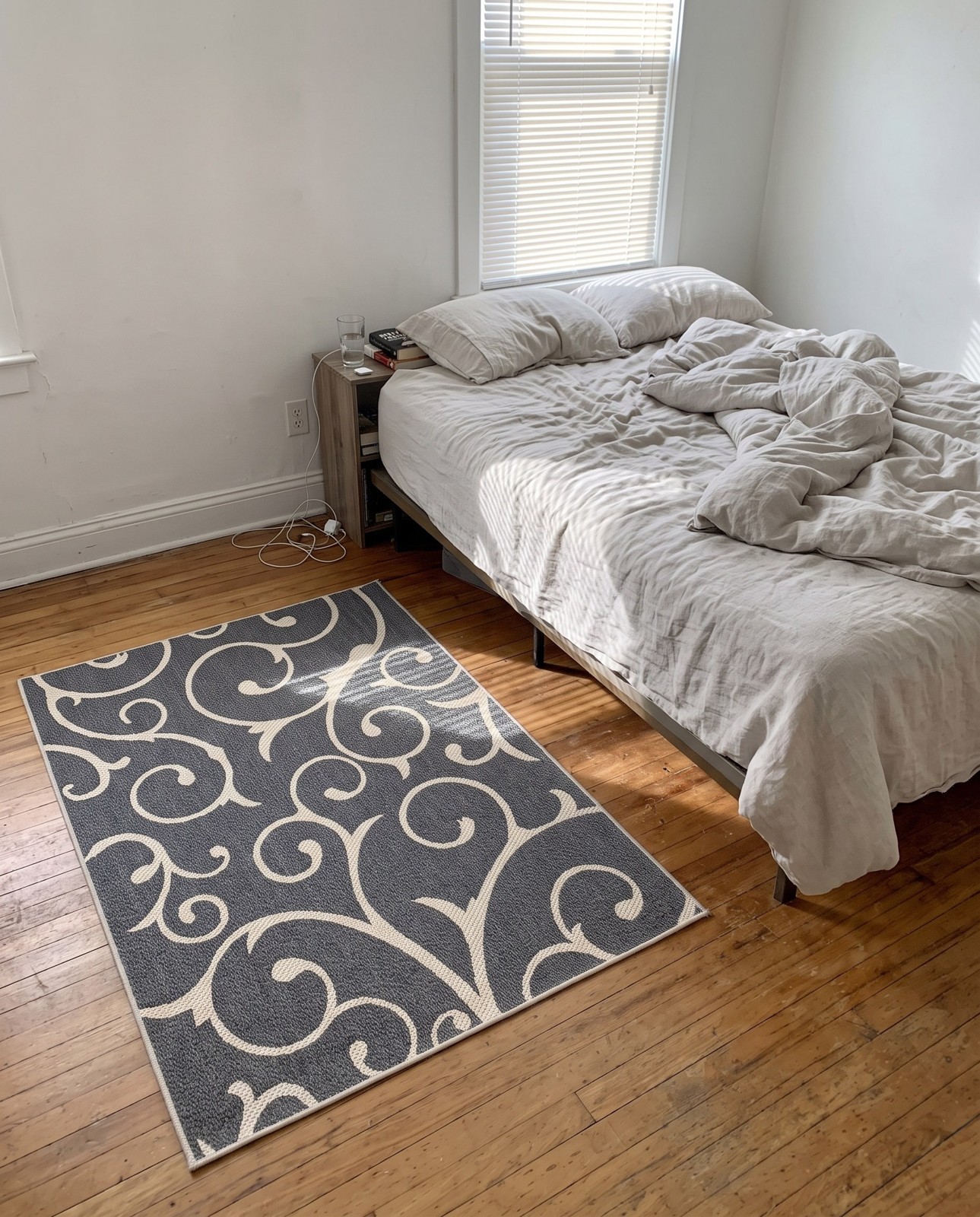Detail image of 4' 2 x 6' Sylvia · Scrollwork rug, dark gray and ivory
